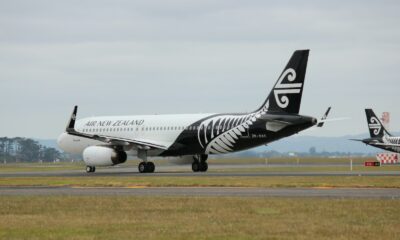 white and black airplane on brown field during daytime